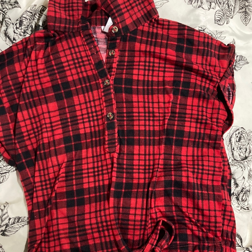 Red and black plaid striped shirt. Sleeveless, tie up, button half way down.